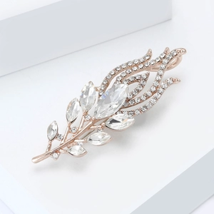 Macro detail of elegant rose gold peacock feather brooch with sparkling rhinestones