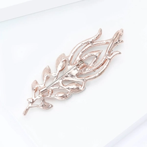 Rose gold feather brooch back showing the secure pin and detailed hollow structure