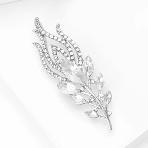 Macro shot of silver feather brooch with sparkling white zircons and marquise crystals