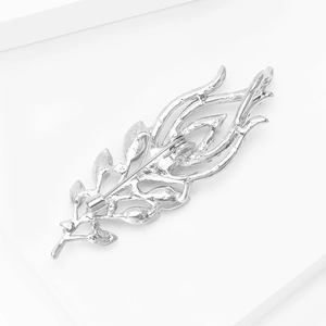 Detail view of the silver peacock feather brooch back showing the pin fastener and texture