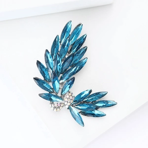 Detailed macro view of luxury blue bowknot brooch with marquise-cut crystals and alloy base
