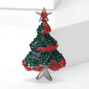Detailed view of elegant Christmas tree brooch featuring green rhinestones and red accents