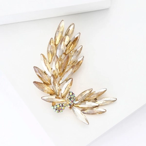 Detail of leaf-shaped brooch with champagne marquise crystals and golden base