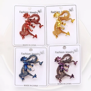 Macro detail of dragon lapel pins in four colors with enamel finish and display cards