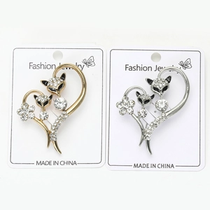 Detailed macro view of fox heart brooches with sparkling white rhinestones and enamel eyes