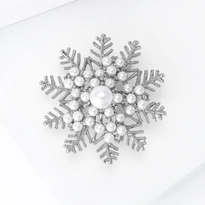 Macro shot of snowflake pearl brooch with silver metal finish and intricate rhinestone details