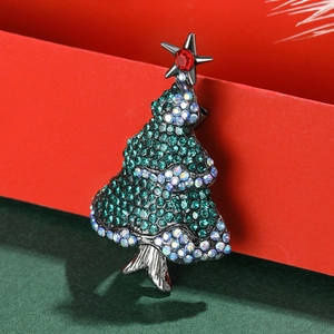 Elegant Christmas tree brooch with green crystals and a red star on a gunmetal base