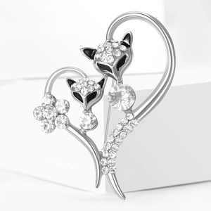 Macro shot of silver fox heart brooch with sparkling rhinestones and black enamel eyes