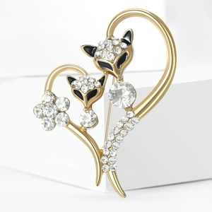 Detailed close-up of golden fox heart brooch with sparkling rhinestones and black enamel