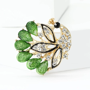Elegant peacock brooch with green teardrop wings and sparkling rhinestones on gold base
