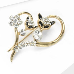 Detail of fox heart brooch featuring gold alloy finish and sparkling white rhinestones