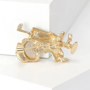 Golden nurse brooch back view showing secure pin closure and textured metal surface