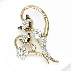 Close-up of heart fox brooch with white crystals and black enamel in gold finish