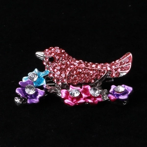 Sparkling pink rhinestone bird brooch with colorful crystal flowers on silver branch