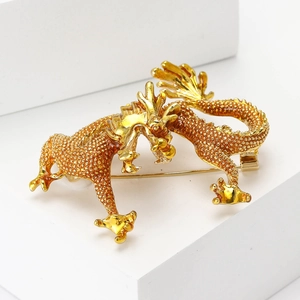 Vintage gold enamel dragon brooch with textured scales for suits and formal wear