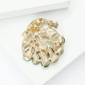 Macro shot of peacock brooch back with golden alloy texture and secure pin clasp