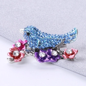 Blue rhinestone bird brooch pin with colorful enamel flowers on silver branches