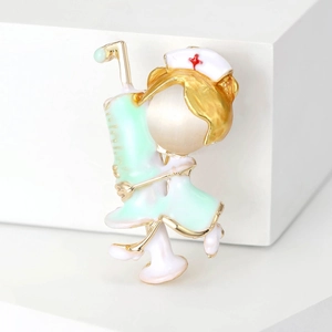Detail of cartoon nurse brooch with mint green enamel and opal-like stone bead