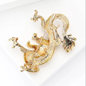 Detailed back view of golden dragon brooch showing secure pin clasp and metal texture
