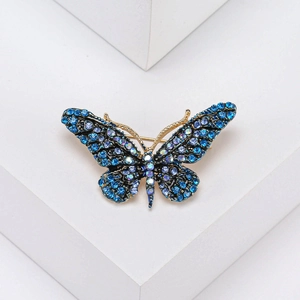 Exquisite butterfly brooch with blue and purple crystals on a gold metal base