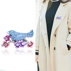 Sparkling blue rhinestone bird brooch with pink flowers on a silver branch for women