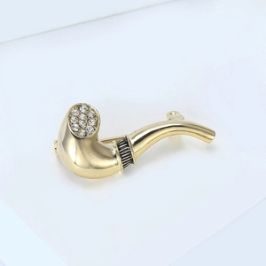 Detail view of gold pipe brooch with sparkling rhinestones and black enamel accents