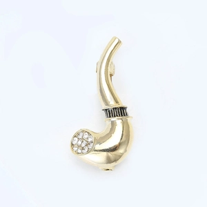 Close-up of golden tobacco pipe brooch featuring black enamel stripes and crystal stones