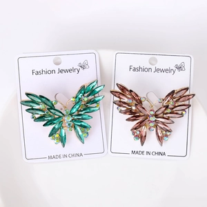 Macro detail of rhinestone butterfly brooches with marquise-cut crystals on display