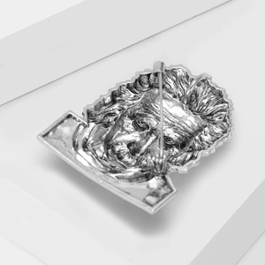 Macro view of Albert Einstein portrait brooch featuring detailed silver metal relief