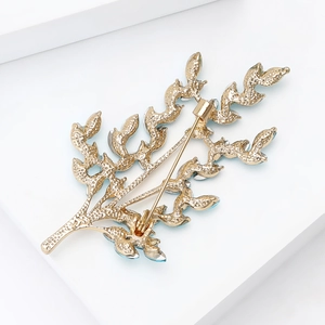 Detailed back view of a golden wheat leaf brooch featuring secure pin clasp and fine texture