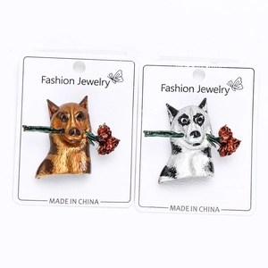 Detail of creative husky enamel brooches holding red roses on a jewelry display card