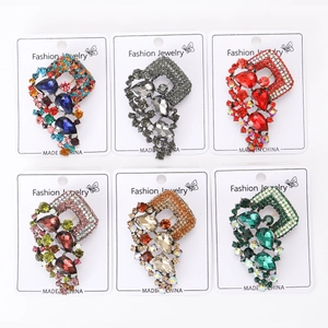 Macro detail of alloy rhinestone brooches in six colors on white fashion jewelry cards