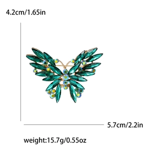 Elegant emerald green crystal butterfly brooch with rhinestone accents in gold finish