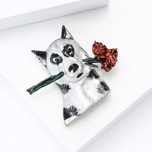 Detail of husky brooch with red roses, featuring enamel craft on polished metal alloy