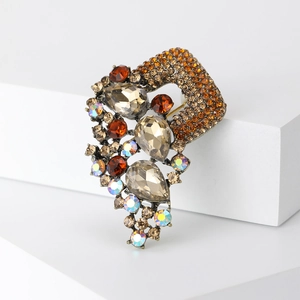 Detailed macro shot of vintage alloy brooch with amber crystals and rhinestones