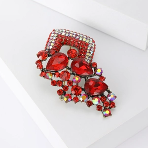 Detailed close-up of vintage alloy brooch with red crystals and colorful rhinestones