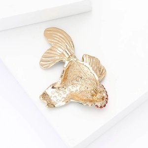 Detailed back view of goldfish brooch showing the safe pin and gold alloy hollow pattern