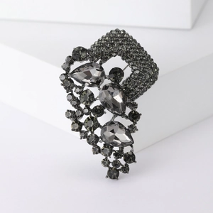 Vintage dark grey alloy brooch with teardrop crystals and pavé rhinestones on white block