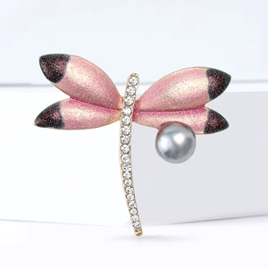 Elegant dragonfly brooch with pink gradient wings and grey pearl on white pedestal