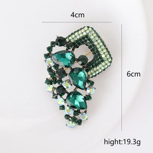 Vintage silver-tone alloy brooch with emerald green crystals and sparkling rhinestones