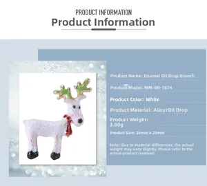 Macro detail of white enamel reindeer brooch with green antlers and red scarf accents