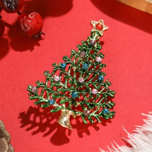 Creative Christmas tree brooch in green enamel with colorful rhinestones on red background