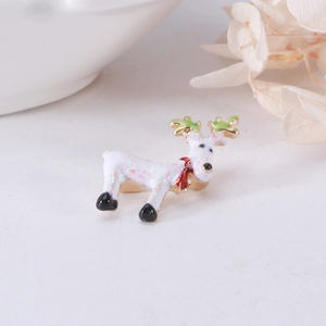 Detailed view of an alloy reindeer brooch with white enamel, glitter, and a red scarf