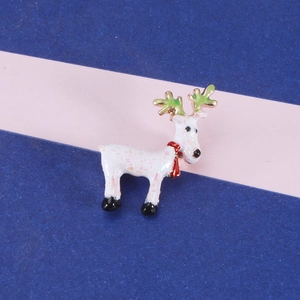 Detailed close-up of a Christmas reindeer brooch with white enamel and glitter accents