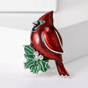 Red enamel cardinal bird brooch on holly leaf with blue and white rhinestones