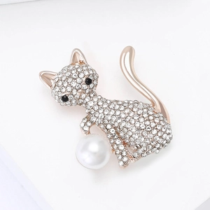 Detail of rose gold cat brooch with sparkling crystals and a white faux pearl accent
