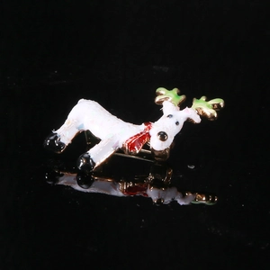 Macro shot of an enamel reindeer brooch with colorful sparkles and a red scarf detail
