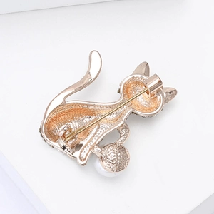 Close-up of the cat brooch back structure with golden metal texture and pin fastener