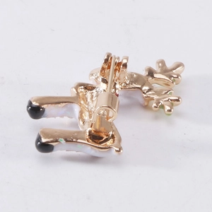 Back view of a Christmas reindeer brooch showing the alloy gold plating and pin closure