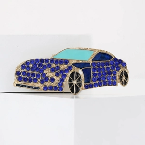 Detailed view of luxury gold-plated sports car brooch with sparkling deep blue rhinestones